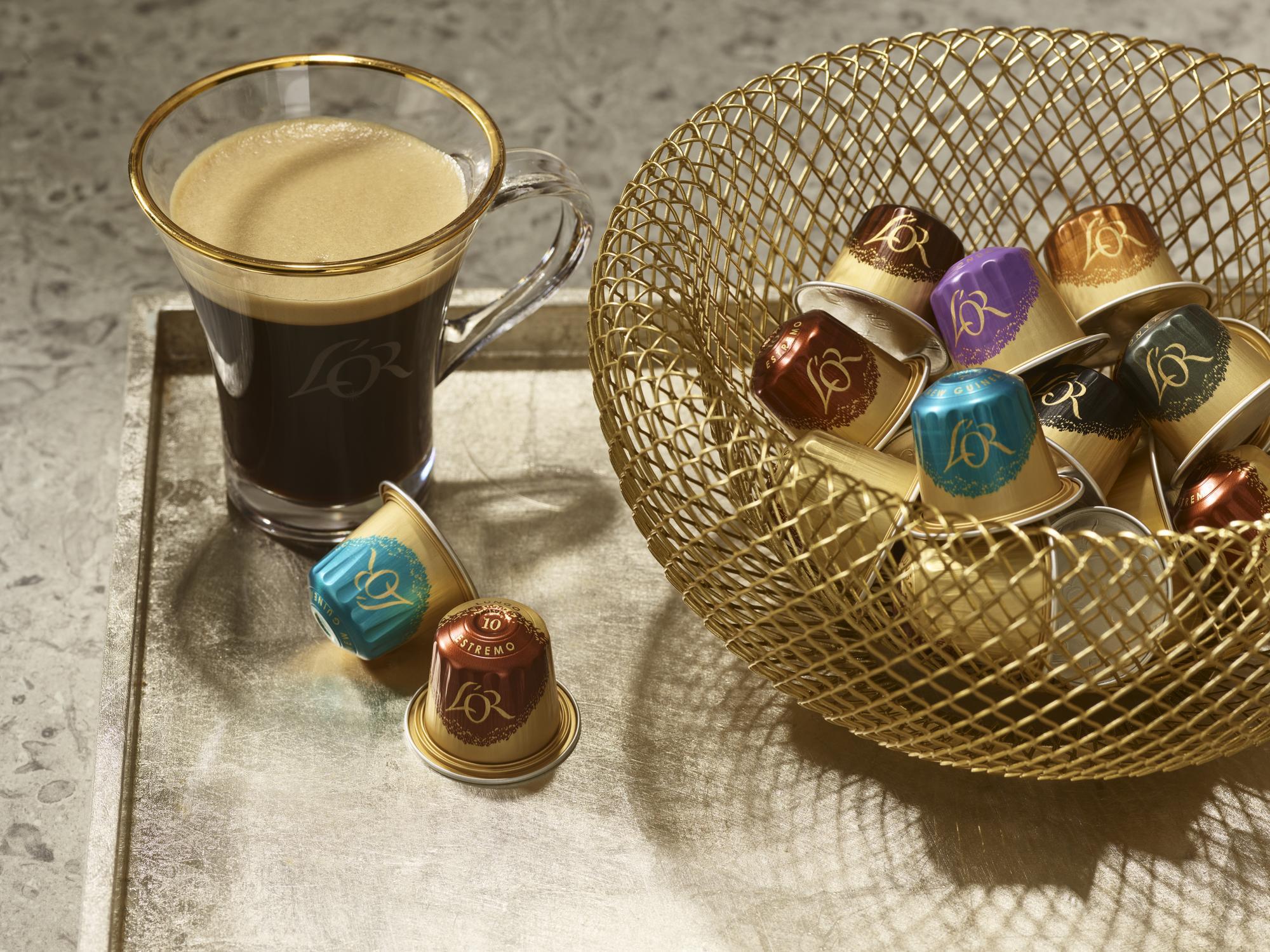 Glass of coffee with coffee capsules on a textured surface