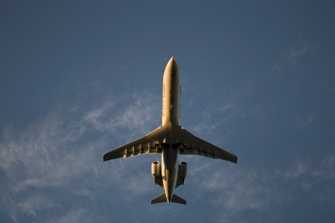 A plane flying overhead in a blue sky